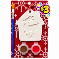 House-shaped plaster ornament with a reindeer design, brown and red paints and a paintbrush on a red snowflake card.