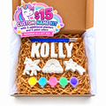 Unicorn custom name paint kit with plaster letters, unicorn, rainbow and shooting star shapes, five paint colors and two brushes in a gift box.