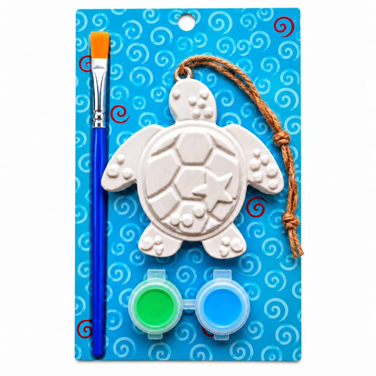 A turtle-shaped plaster craft kit on a blue patterned backing card, including a white unpainted turtle shell, a blue paintbrush with an orange bristle cap, two small paint pots in green and blue, and a brown rope loop.