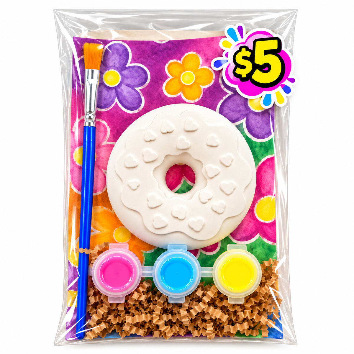 Plaster donut paint kit with heart decorations, three paint colors and a paintbrush in clear packaging with a floral background.